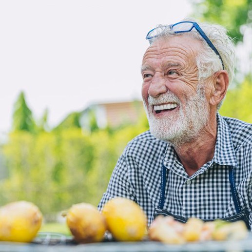 Man smiles outdoors