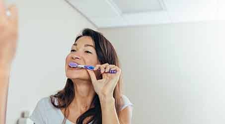 a woman brushing her teeth