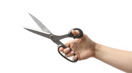 Patient holding black scissors