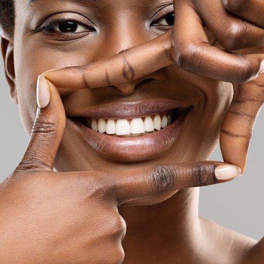 Woman outlining her smile with her fingers